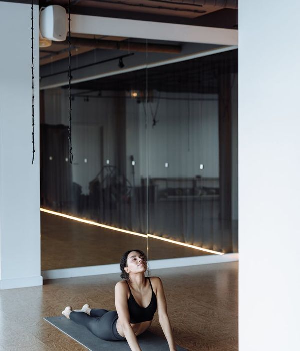 Young woman practicing yoga in a bright minimalistic studio space